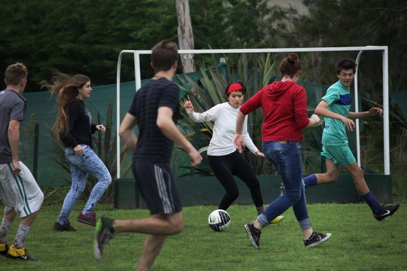Students play soccer on a pitch