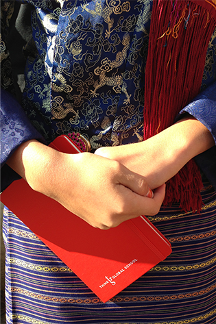 A student clutches their journal