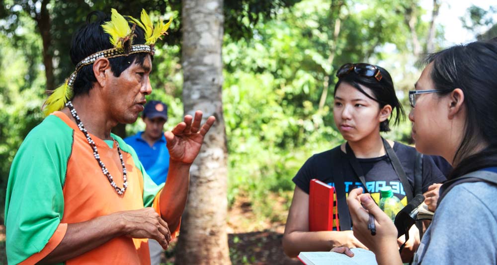 TGS students Yada and Charis converse with a Guarani shaman