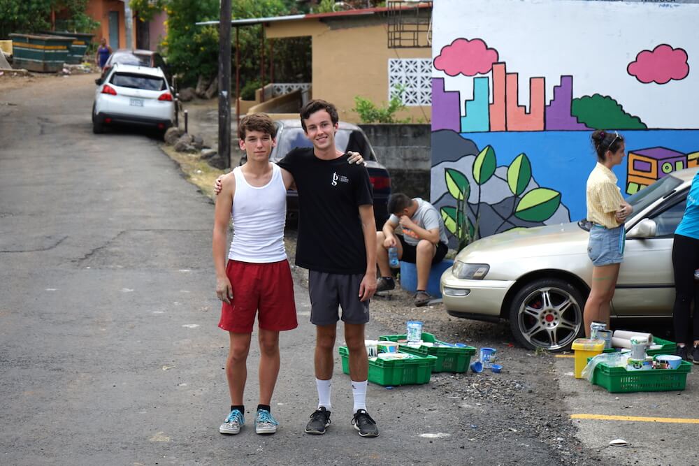 Xavier and Joshua painting the mural at Fundación Sembrarte